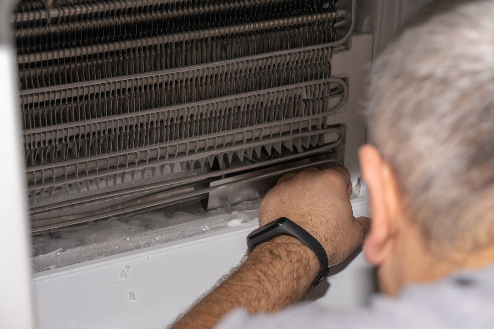 a man inspecting a freezer