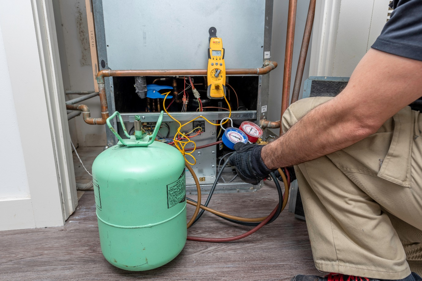 Technician checking refrigerant level