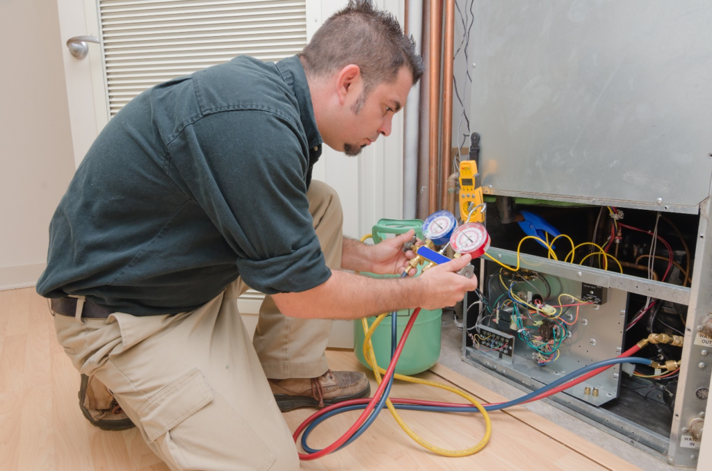 Technician performing refrigerator maintenance
