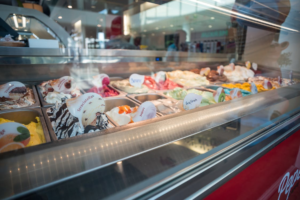 A freezer with ice cream flavors displayed in it