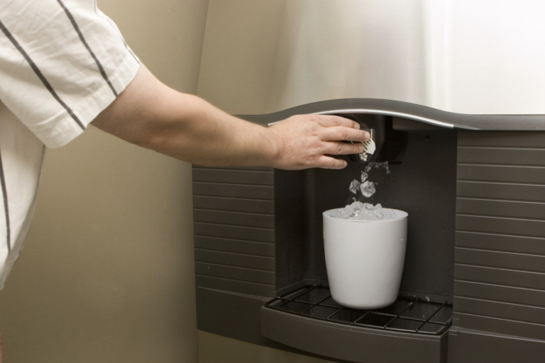 A person filling a bucket with ice