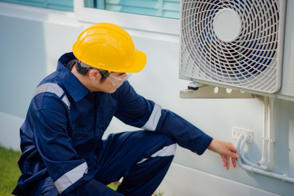 A technician inspecting an airconditioner