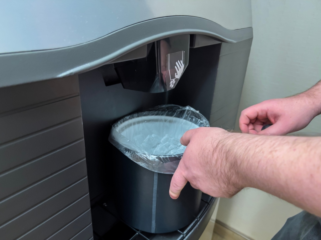 A person taking out ice cubes from an ice machine