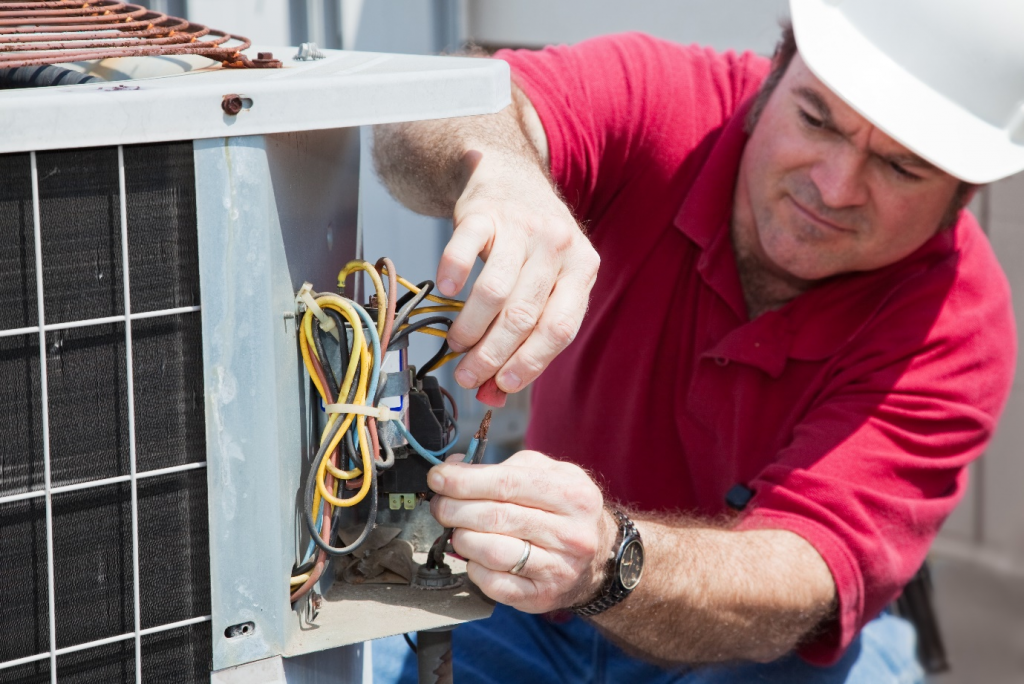 A man repairing an air conditioner