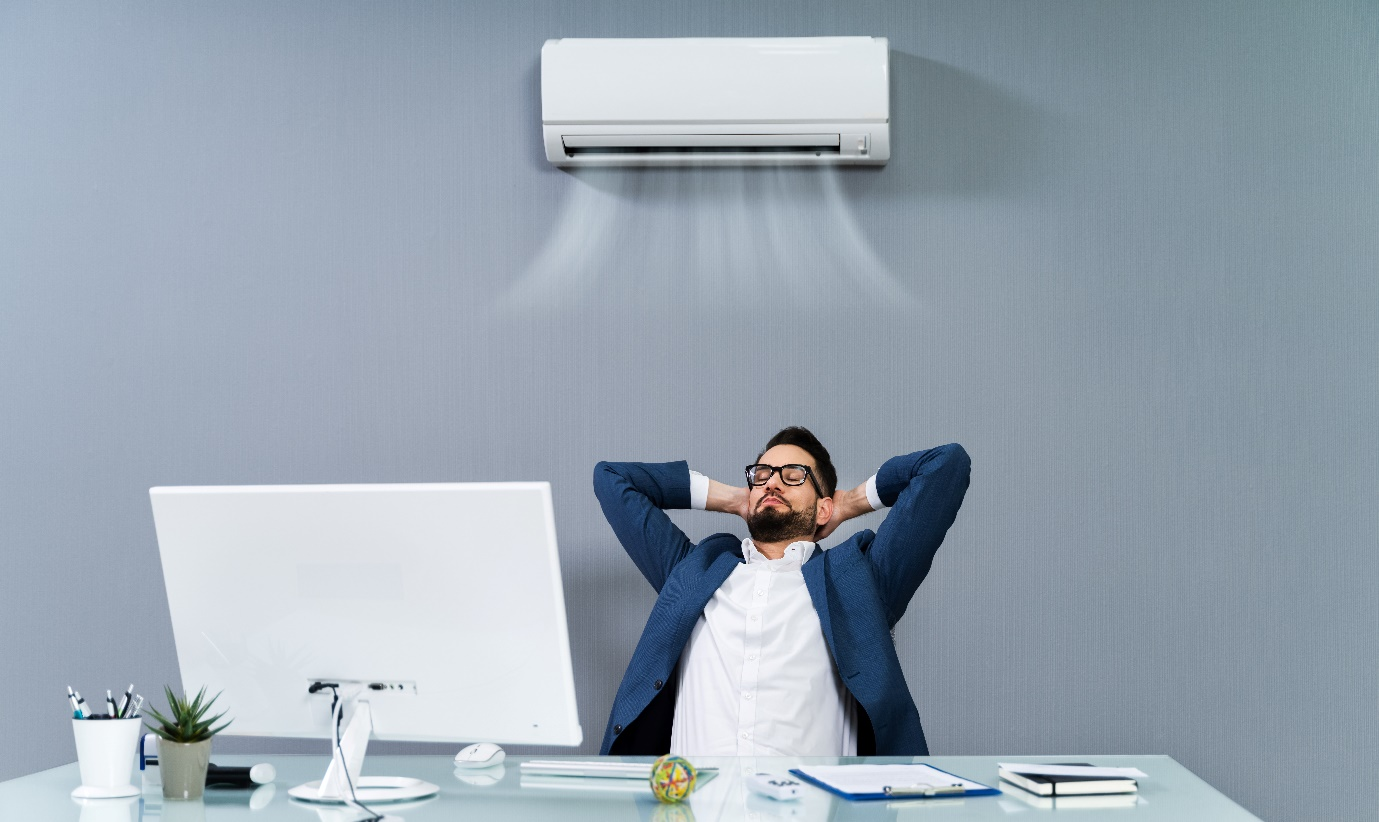  A person enjoying air conditioning in his office